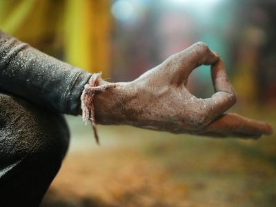Close-up of hands in a yoga mudra gesture.