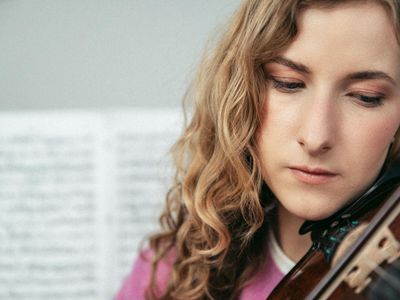 Soft focus on a woman's calm facial expression during practice.
